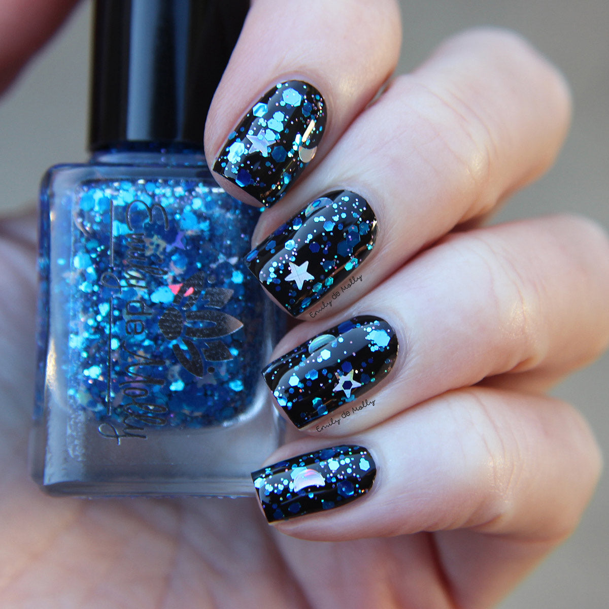 A closeup of a woman's hands with metallic royal blue nail polish that has  large blue glitter flakes | Blue glitter nails, Blue nails, Glitter accent  nails